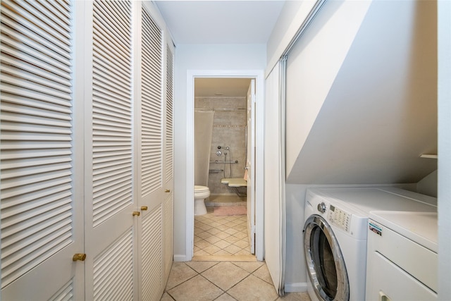 laundry room featuring laundry area, light tile patterned flooring, and washing machine and dryer