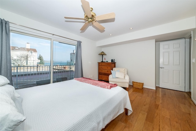 bedroom featuring access to outside, baseboards, ceiling fan, and wood finished floors