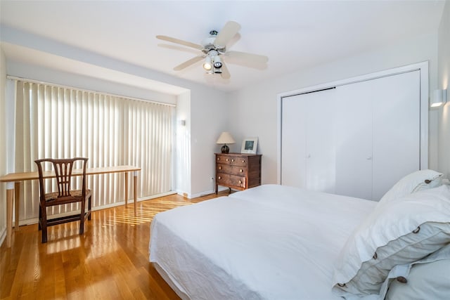 bedroom with a closet, ceiling fan, and light wood finished floors