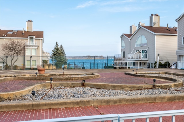 view of home's community featuring fence