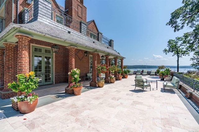 view of patio / terrace featuring a balcony and french doors