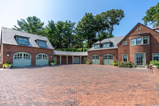 view of front of property with brick siding, driveway, and an attached garage