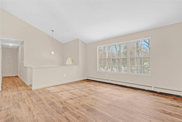 empty room with lofted ceiling, a baseboard radiator, light wood-style flooring, and baseboards