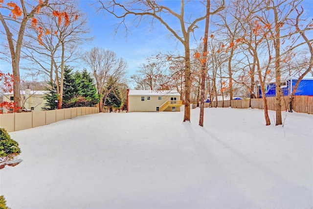 yard layered in snow with fence