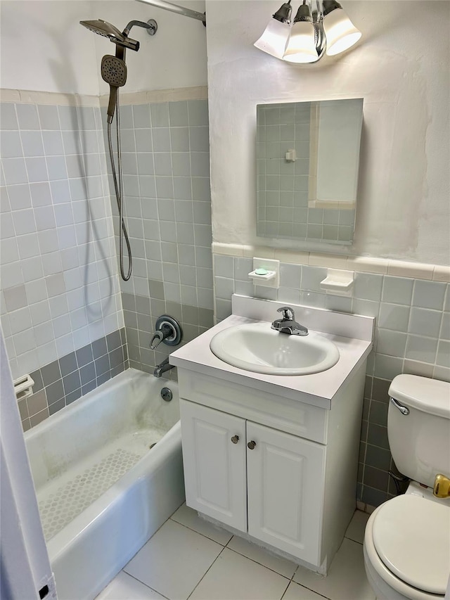 full bathroom featuring tile walls, bathtub / shower combination, toilet, vanity, and tile patterned flooring