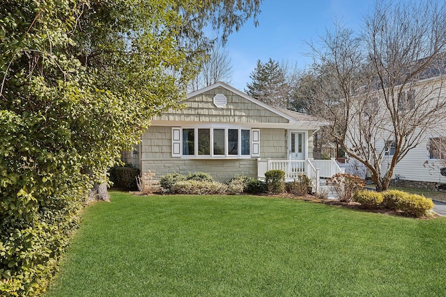 view of front of home with stone siding and a front yard