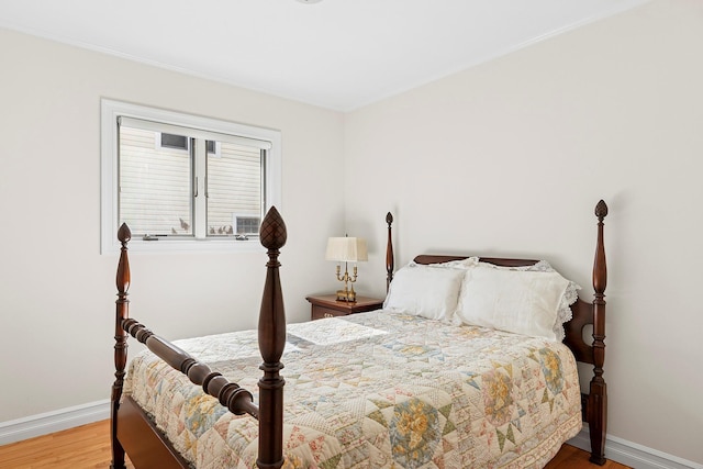 bedroom with wood finished floors and baseboards