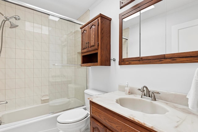 bathroom with enclosed tub / shower combo, vanity, and toilet