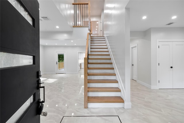 staircase with marble finish floor, baseboards, visible vents, and recessed lighting