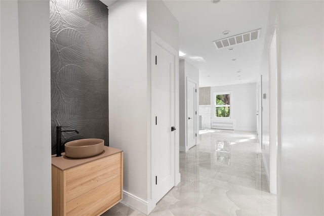 hallway featuring marble finish floor, baseboards, and visible vents