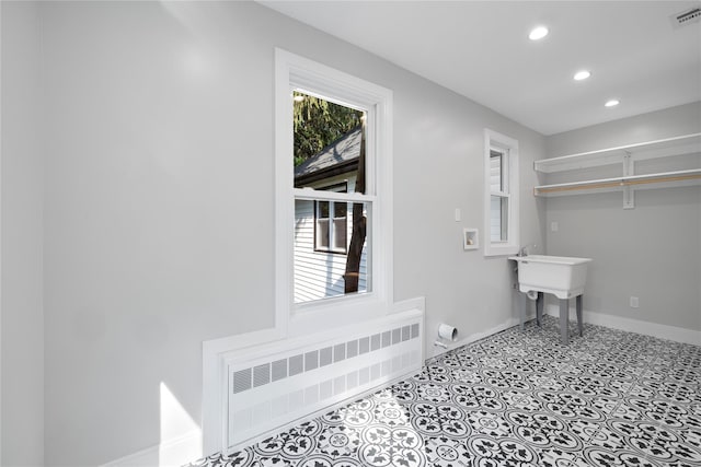 laundry room featuring recessed lighting, laundry area, visible vents, baseboards, and radiator heating unit