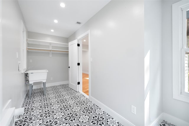 clothes washing area featuring recessed lighting, visible vents, and baseboards