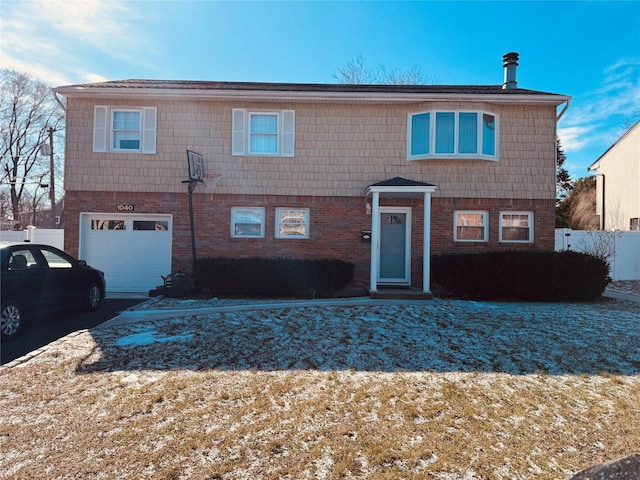 view of front of home featuring a garage, brick siding, and driveway