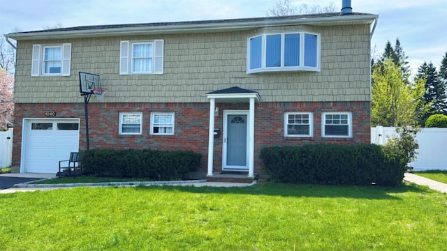 view of front of home featuring brick siding, fence, and a front yard