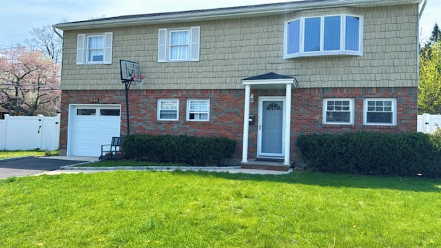 view of front of home with fence, a front lawn, driveway, and a garage