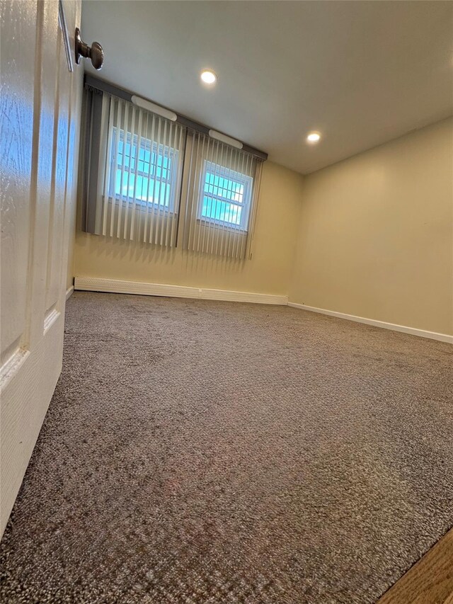 carpeted empty room featuring baseboards and recessed lighting