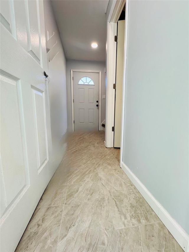 corridor featuring recessed lighting and baseboards
