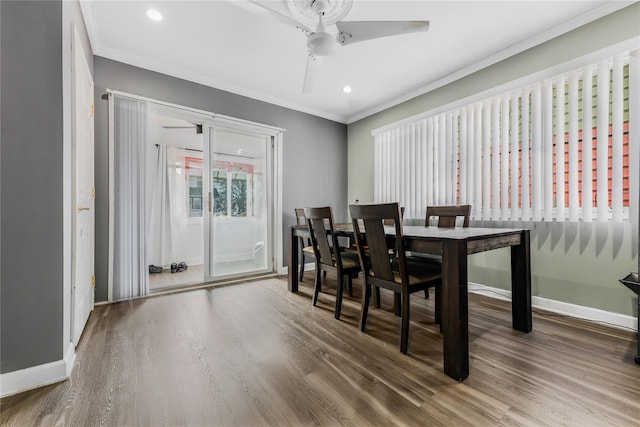 dining area with ornamental molding, baseboards, and wood finished floors