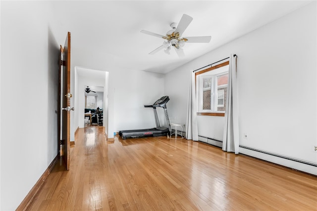 workout room featuring light wood-style floors, a baseboard radiator, and a ceiling fan