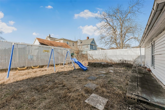 view of playground featuring a fenced backyard