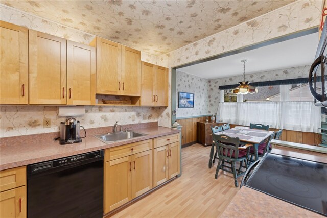 kitchen featuring light countertops, dishwasher, a sink, and wallpapered walls