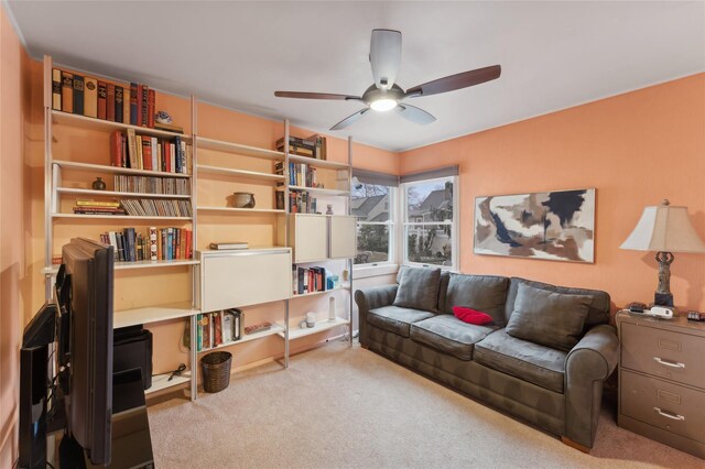 carpeted living room with a ceiling fan