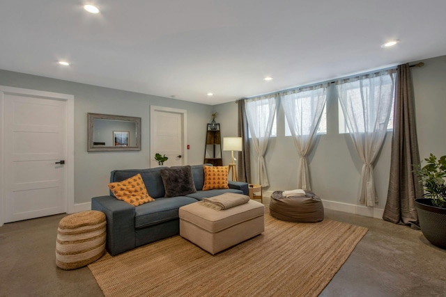 living area featuring recessed lighting and baseboards