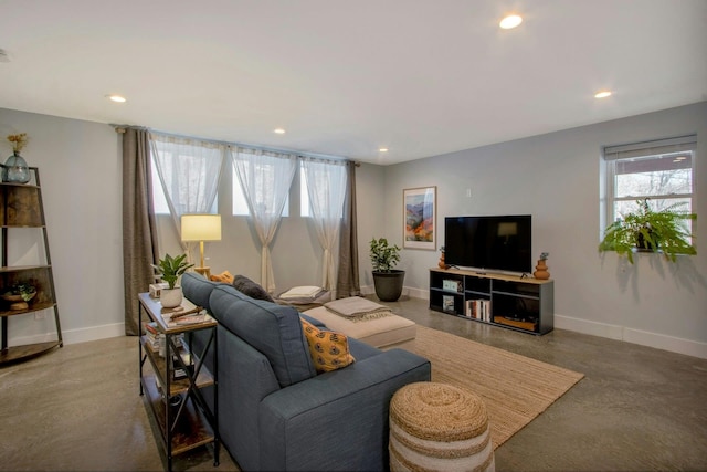 living room featuring recessed lighting, concrete flooring, and baseboards