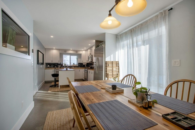 dining area featuring recessed lighting and baseboards