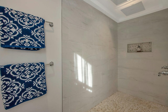 full bath with speckled floor and a tile shower