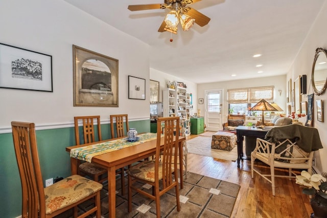 dining space featuring wood finished floors and recessed lighting