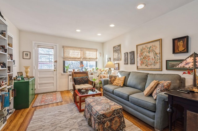 living area with light wood-type flooring and recessed lighting