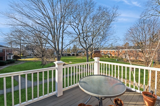 wooden terrace featuring a yard and a residential view