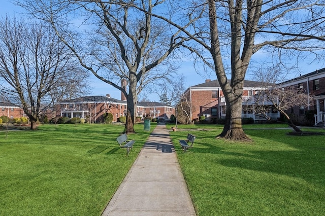 surrounding community featuring a yard and a residential view