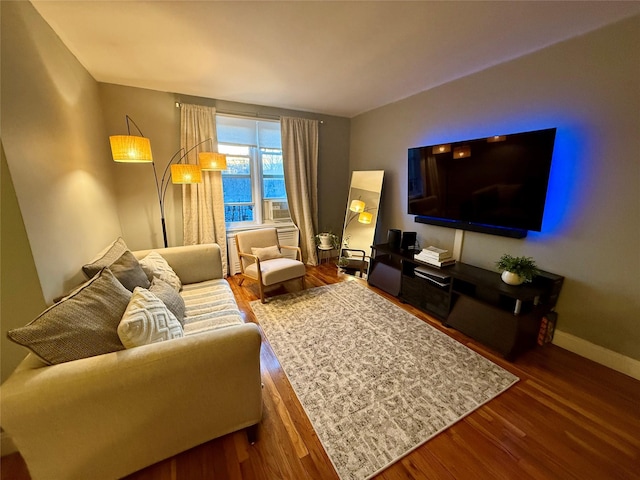 living area featuring baseboards and wood finished floors