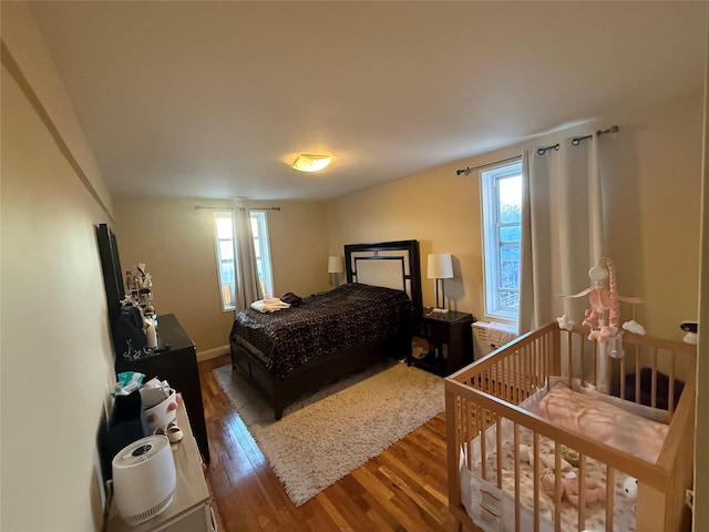 bedroom featuring dark wood-style floors and baseboards