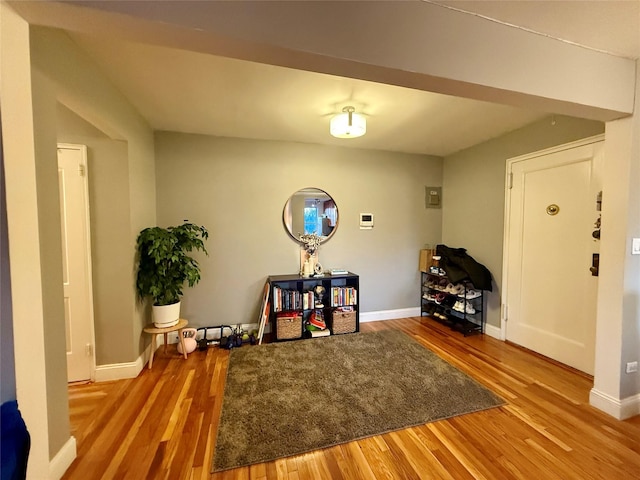 interior space featuring baseboards and wood finished floors