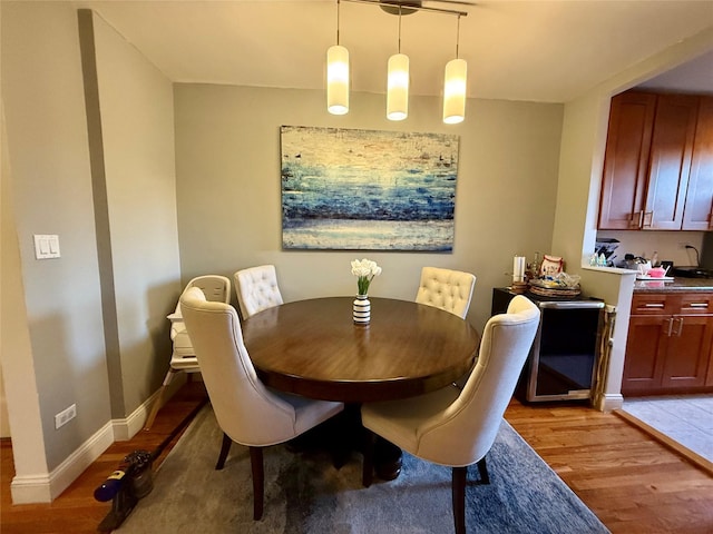 dining area featuring light wood-type flooring and baseboards