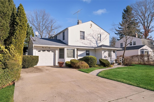 view of front of house featuring a garage, driveway, a chimney, and a front lawn