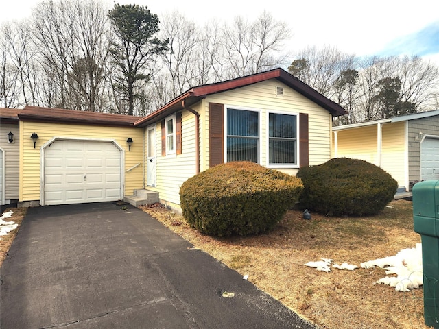 view of home's exterior with a garage and aphalt driveway