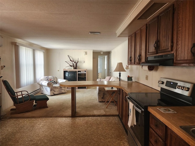 kitchen with carpet floors, electric stove, visible vents, open floor plan, and under cabinet range hood