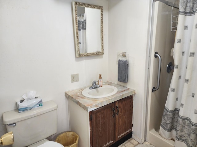 full bathroom with a stall shower, vanity, and toilet