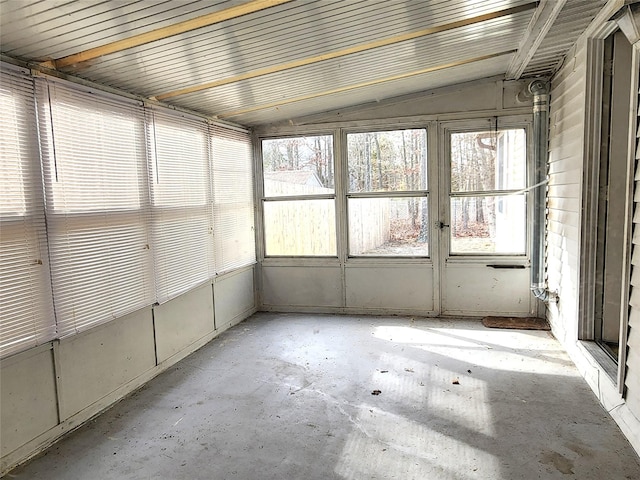 unfurnished sunroom featuring vaulted ceiling