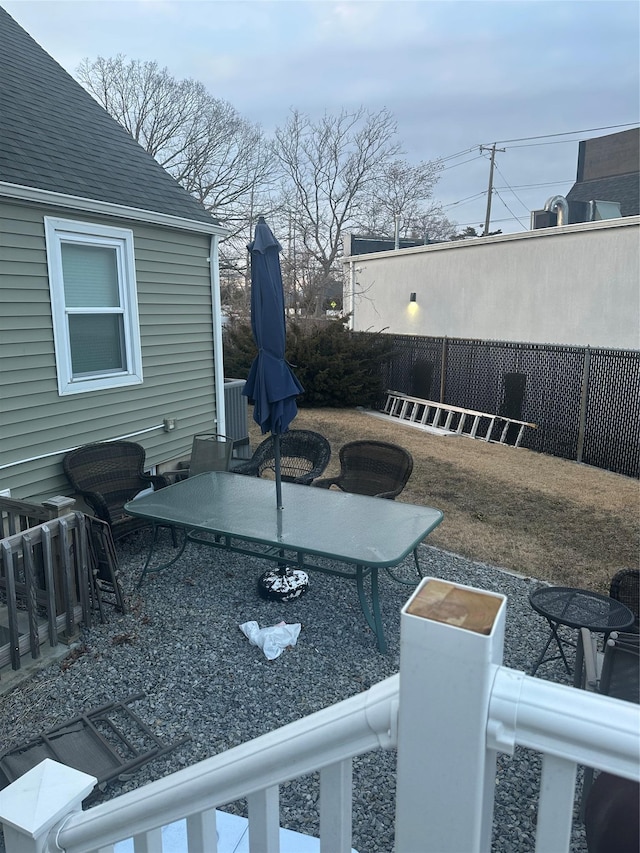 view of yard with outdoor dining area and fence