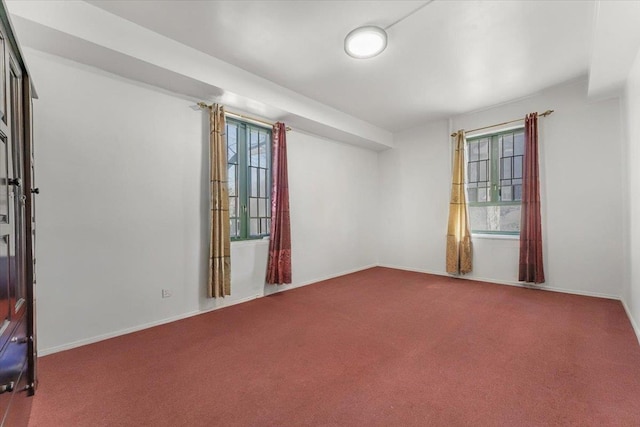 empty room with carpet floors and baseboards