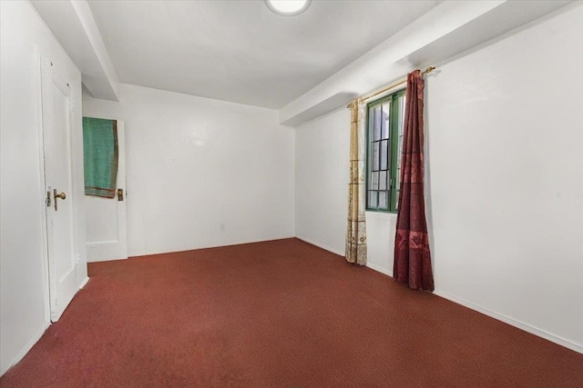 spare room with dark carpet