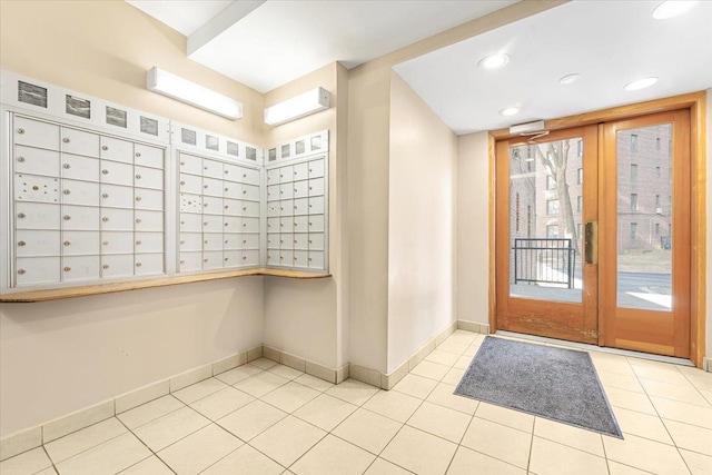 interior space with light tile patterned floors, mail area, baseboards, and recessed lighting