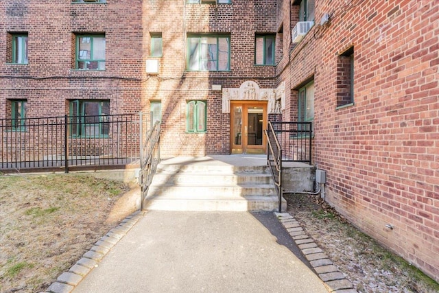 entrance to property with cooling unit and brick siding