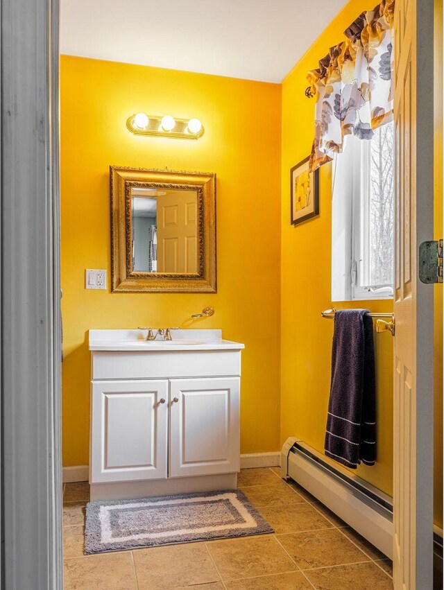 bathroom featuring baseboards, baseboard heating, vanity, and tile patterned floors