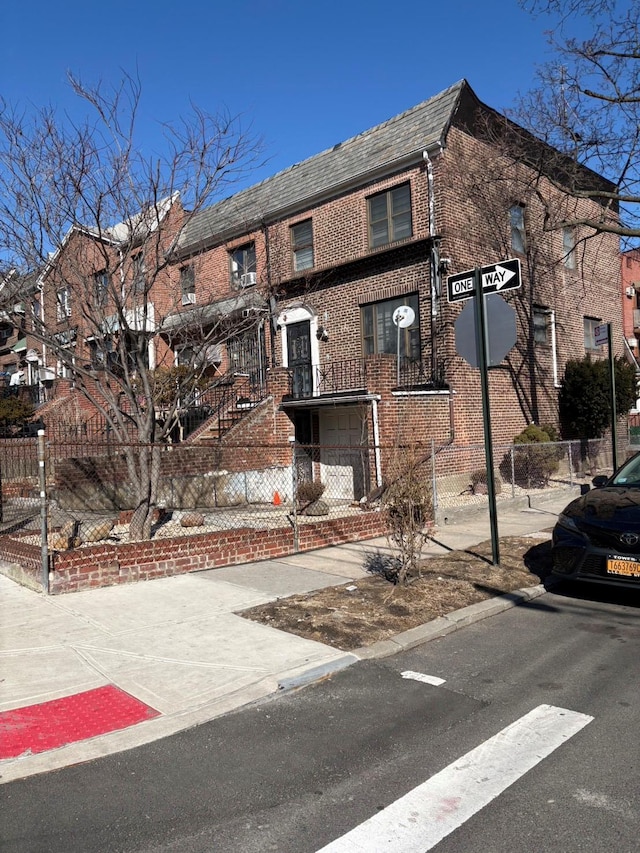 view of building exterior featuring a fenced front yard